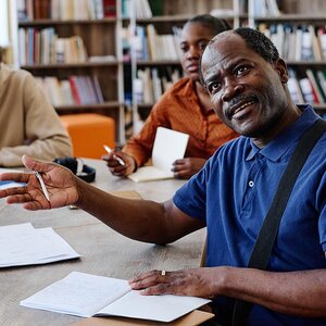 An older college student asking a question in class.