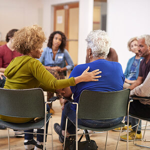 A group of people talking in a circle. A group of people talking in a circle.