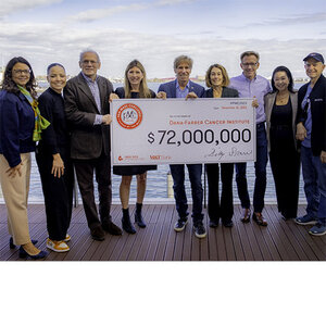 A group of people displaying a mock check for $72,000,000. A group of people displaying a mock check for $72,000,000.