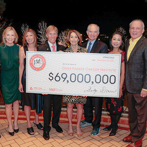 Several people involved with the Pan-Mass Challenge fundraising event stand behind a large check for $69 million. Several people involved with the Pan-Mass Challenge fundraising event stand behind a large check for $69 million.