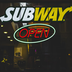 A neon Subway restaurant sign. A neon Subway restaurant sign.