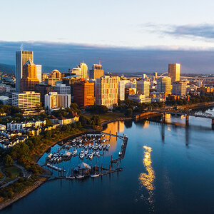 An aerial view of Portland, Oregon, including a bridge over the Willamette River.