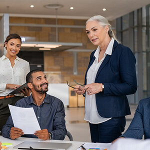 A woman executive leading a meeting at work.