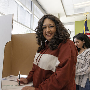 A woman of color voting