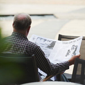 A man reading the local news. A man reading the local news.
