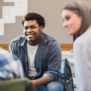 A young person sitting in a talking session.