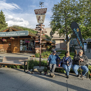 People sitting outside of a visitor's center in Anchorage, Alaska.