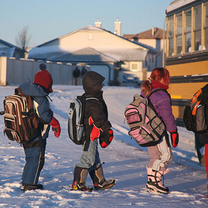Children in line to enter school bus on a winter day.