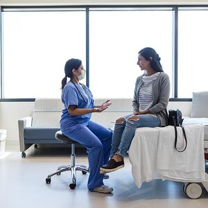 A woman and a doctor talking.