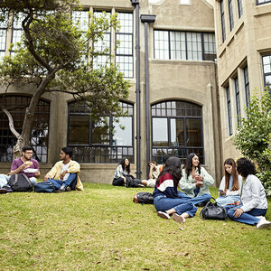 college students sitting outside on campus.