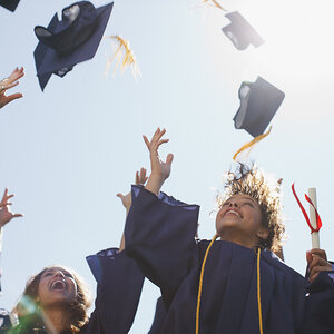 College graduates tossing their caps in the air.