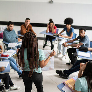 Young people gathering together in a workshop.