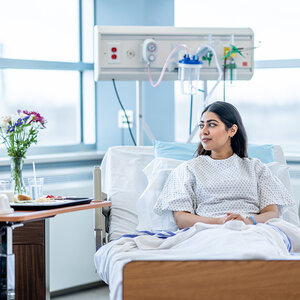 A young woman in a hospital bed. A young woman in a hospital bed.