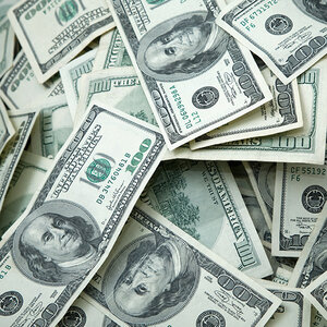A large disordered pile of one-hundred-dollar bills. A large disordered pile of one-hundred-dollar bills.
