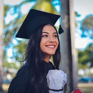 A college student in a cap and gown. A college student in a cap and gown.