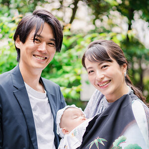 An Asian American family with their baby smile for the camera An Asian American family with their baby smile for the camera