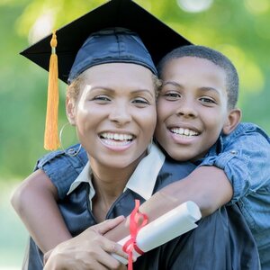 A college graduate in cap and gown with her son.