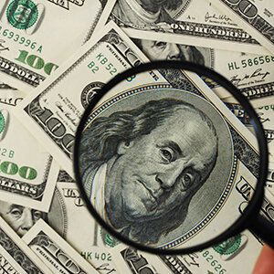 A closeup of $100 bills, featuring Ben Franklin.