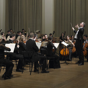 An orchestra performing on stage.