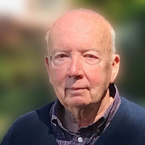 A headshot of an old man wearing a sweater – a photo of Hugh Hoffman A headshot of an old man wearing a sweater – a photo of Hugh Hoffman