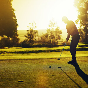A man golfing on a course. A man golfing on a course.