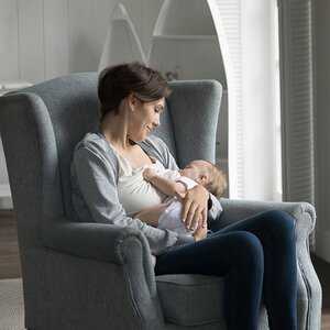 A woman breastfeeding a baby. A woman breastfeeding a baby.