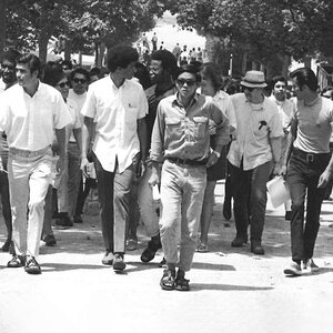Morgan Chu at the center of a group of students marching up Bruin Walk.