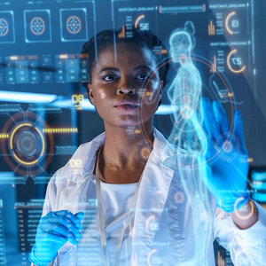 A scientist looks at a transparent screen showing biomedical data. A scientist looks at a transparent screen showing biomedical data.
