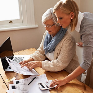 A younger woman looki at a computer looking at  A younger woman looki at a computer looking at