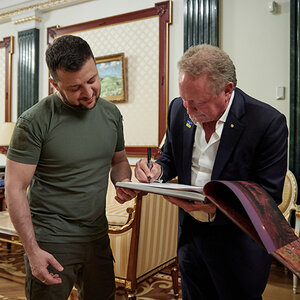 Ukrainian president Volodymyr Zelenskyy stands beside Australian philanthropist Andrew Forrest as Forrest signs a pledge agreement. Ukrainian president Volodymyr Zelenskyy stands beside Australian philanthropist Andrew Forrest as Forrest signs a pledge agreement.