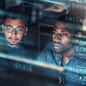 Two men working on a computer.