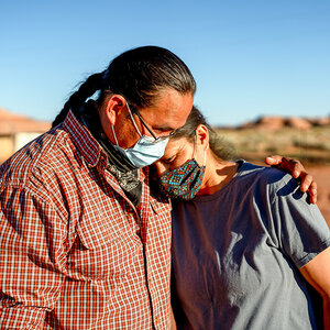 A Native American couple wearing face masks.