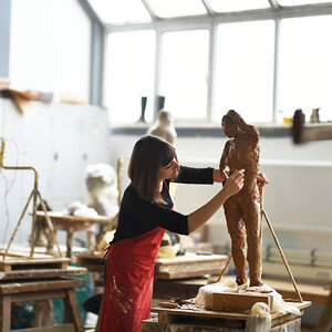 An artist working on her sculpture.