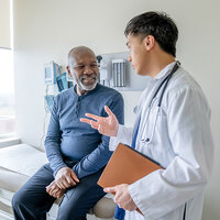 A doctor speaking with a patient. A doctor speaking with a patient.