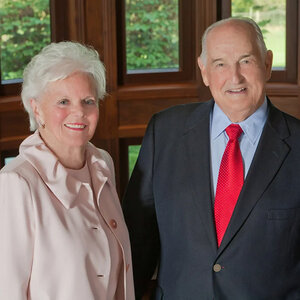 An older couple in business attire pose for a photo – an image of Suzanne and Walter Scott. An older couple in business attire pose for a photo – an image of Suzanne and Walter Scott.