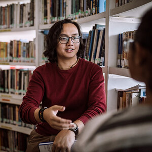 A librarian talking with a patron. A librarian talking with a patron.