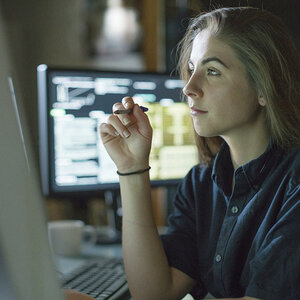 A woman reading the news on a computer. A woman reading the news on a computer.