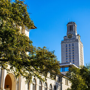 A beautiful college building in the Spanish Southwestern style surrounded by trees with an iconic clock tower in the background. A beautiful college building in the Spanish Southwestern style surrounded by trees with an iconic clock tower in the background.