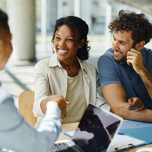 A woman shaking hands with a banker. A woman shaking hands with a banker.
