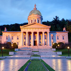 An image of the Vermont statehouse building at dusk, a red glow of sunlight gleaming on the building. An image of the Vermont statehouse building at dusk, a red glow of sunlight gleaming on the building.