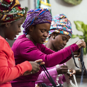 Women weaving a carpet to sell. Women weaving a carpet to sell.
