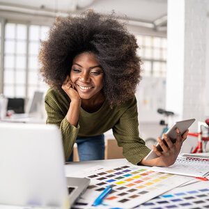 A designer reviewing her projects. A designer reviewing her projects.