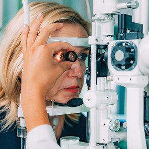 A woman in the middle of an eye exam.