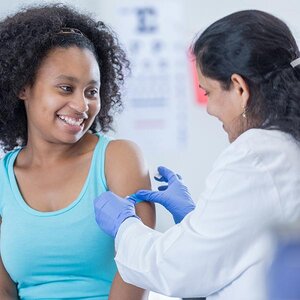 A teenager getting ready for a vaccine. A teenager getting ready for a vaccine.