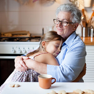 A grandmother hugging her grandchild. A grandmother hugging her grandchild.