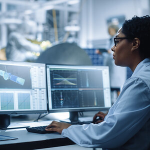 A women working on satellite research. A women working on satellite research.