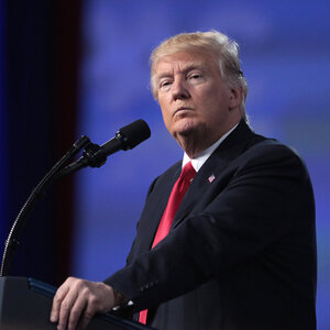 President Donald Trump standing at a podium. President Donald Trump standing at a podium.