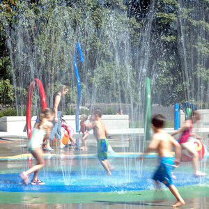 Children playing in a park splash pad.