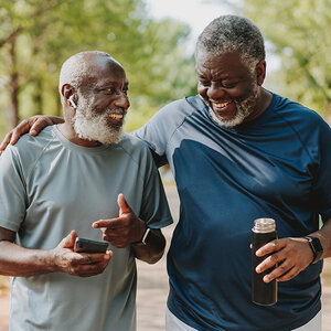 Two older African American men taking a walk in a park. Two older African American men taking a walk in a park.