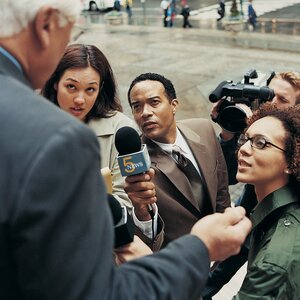 local reporters pressing a subject on the steps of a building local reporters pressing a subject on the steps of a building